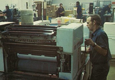RJ Young service man working on a printer in the 70s.